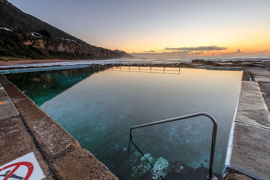blue body of water, pool with warning sign near mountain, sunset HD wallpaper