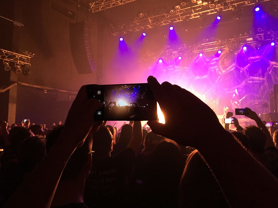 person taking picture at stage with multicolored lights, Concert, Film