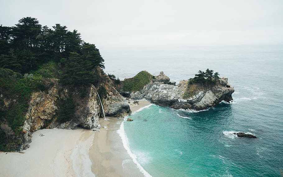waterfalls rushing on to sea, shore during daytime, aerial view HD wallpaper
