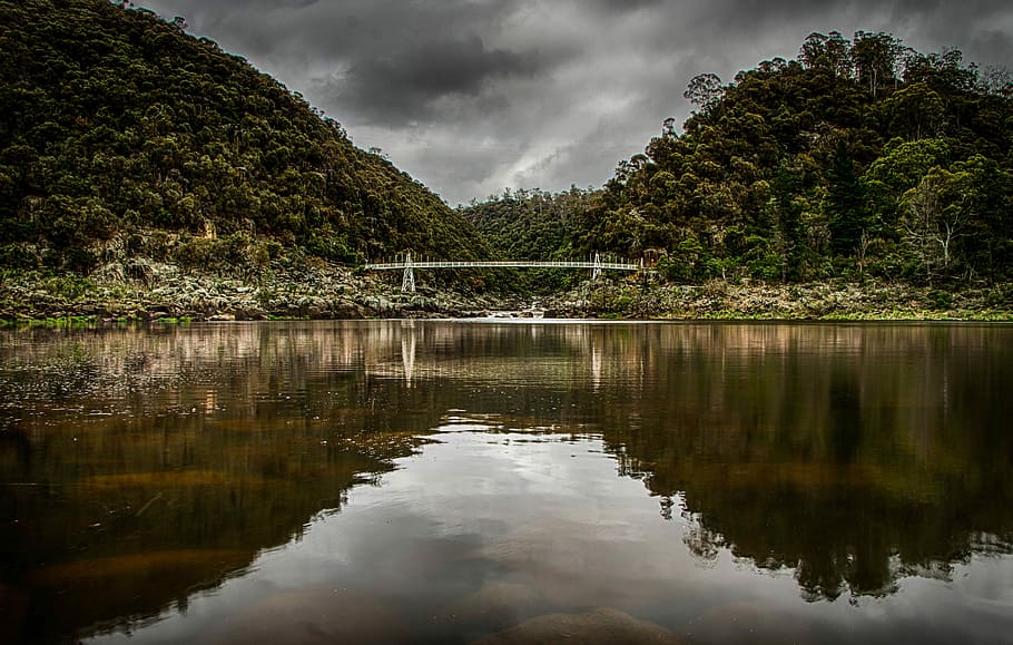 body of water during daytime, landscape photo of body of water near green trees under cloudy sky during daytime HD wallpaper