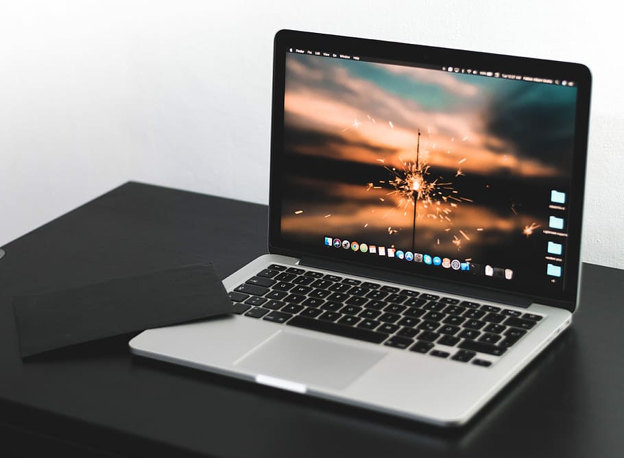 MacBook Pro on wooden table, MacBook Pro on black wooden surface HD wallpaper