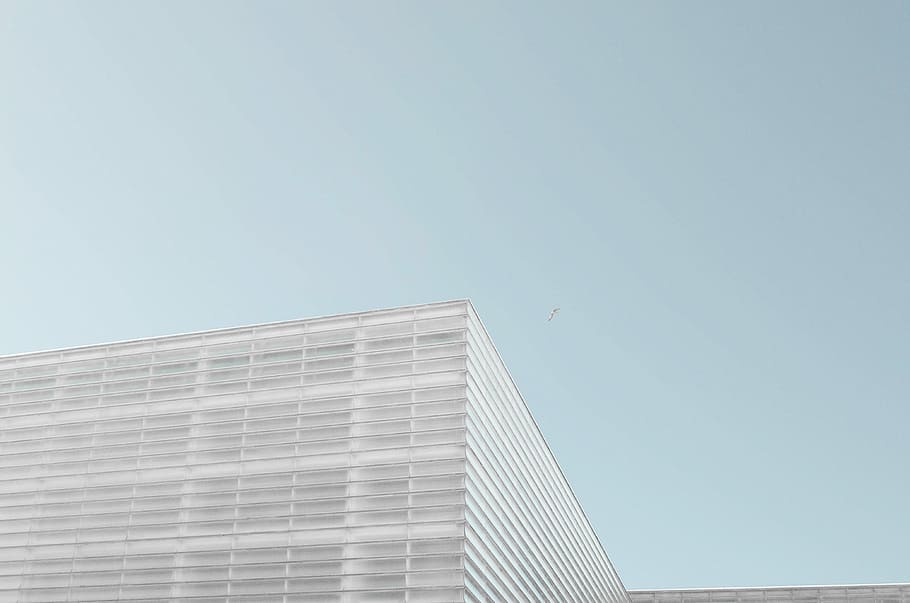 grey concrete building under clear blue sky, low angle photo of gray building HD wallpaper