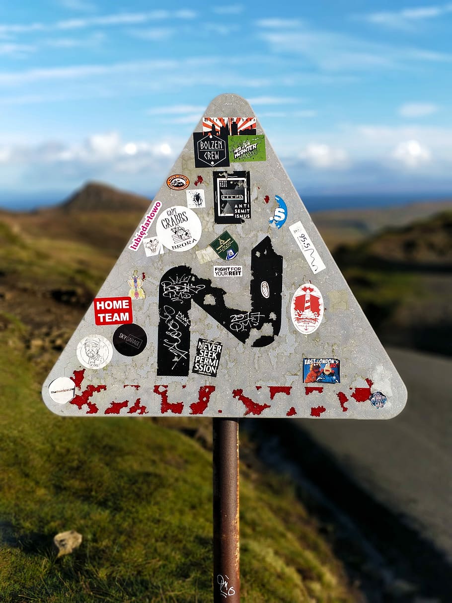 stickers on road signage, white and red road sign during daytime HD wallpaper
