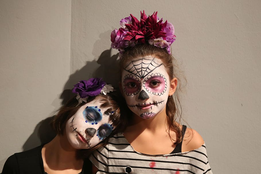 two girl with muerte face paints, castañera, dead, party, halloween