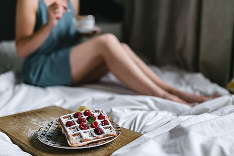 Breakfast in bed - waffles with raspberries and cup of coffee on the tray HD wallpaper