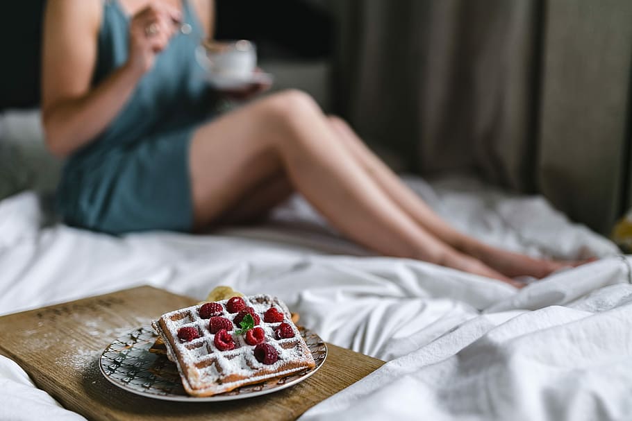 Breakfast in bed - waffles with raspberries and cup of coffee on the tray HD wallpaper