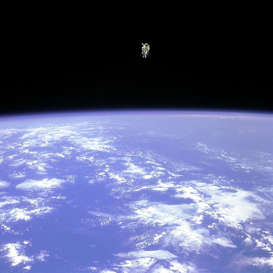 an astronaut floating outside the core of the Earth, space, nasa