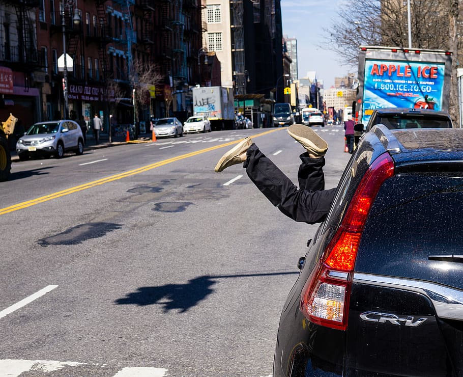 person's feet sticking out window of black Honda CR-V parked at roadside at daytime, HD wallpaper