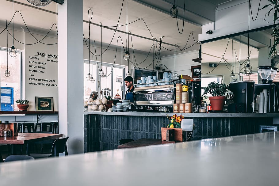 man standing at kitchen, man standing near counter, cafe, coffee shop