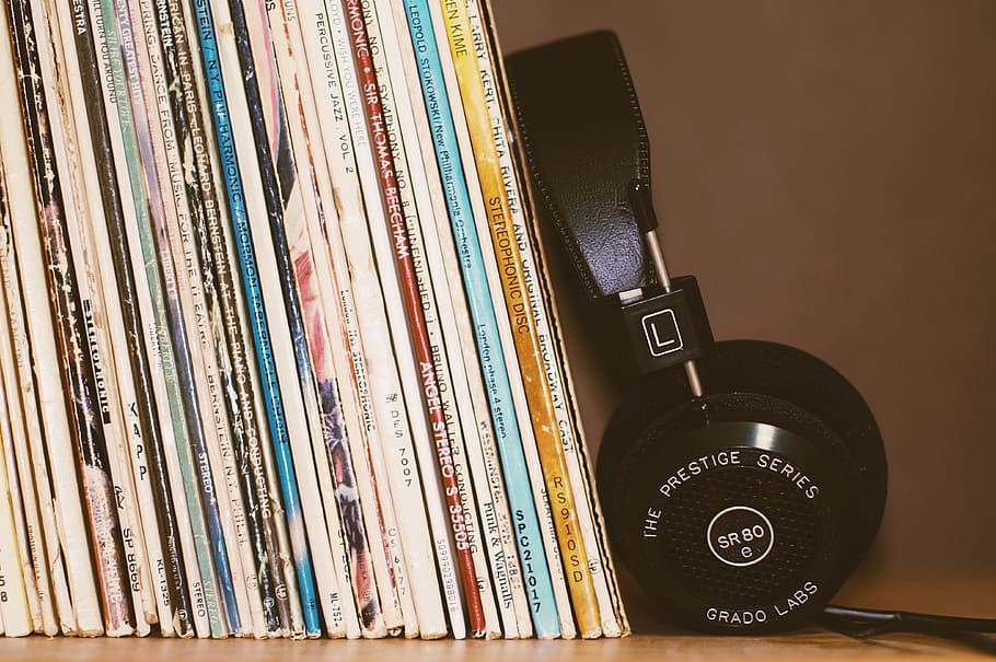 black headset beside books, headphones, music, song, foam, playlist