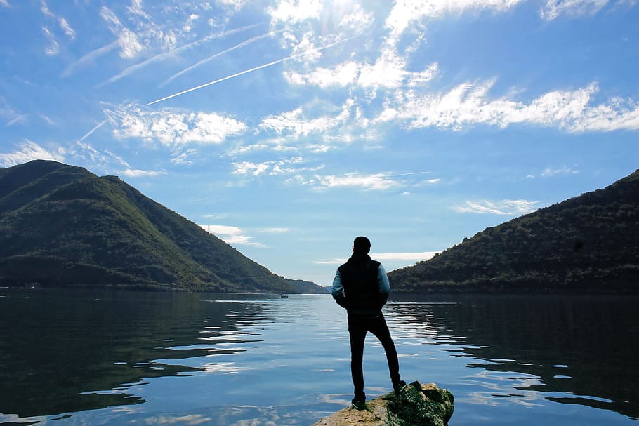 photo of person standing on the rock, man, front, lake, scenery