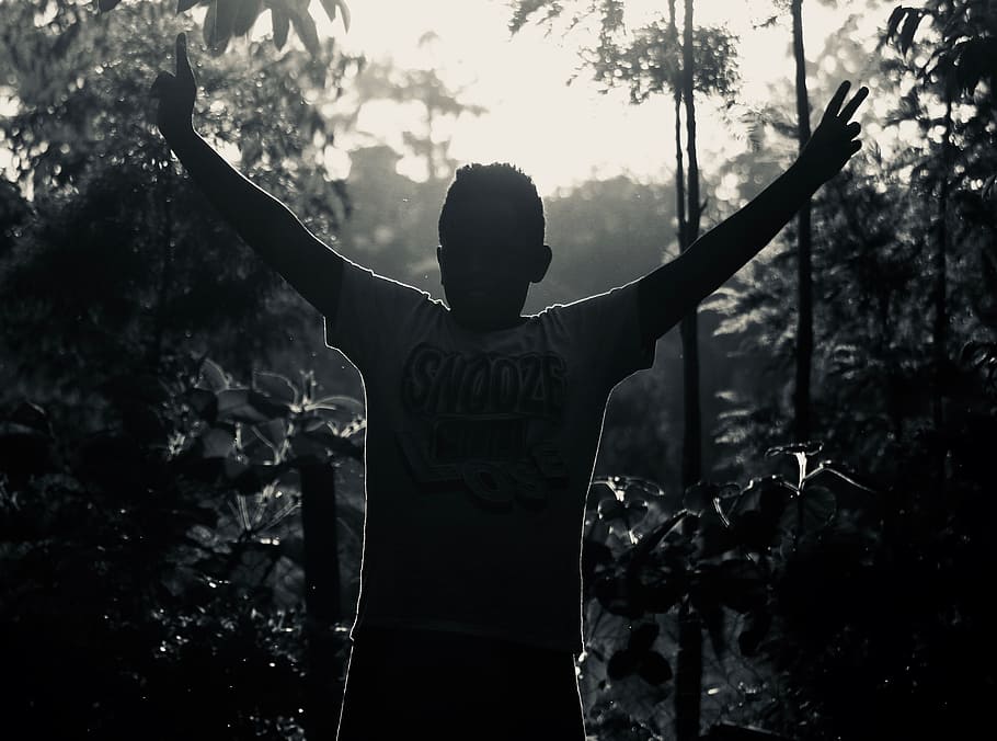 Gray Scale Photo of Man in White Shirt Raising His Hand Near Plants HD wallpaper