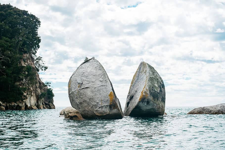 sliced rock on body of water at daytime, sea, ocean, trees HD wallpaper
