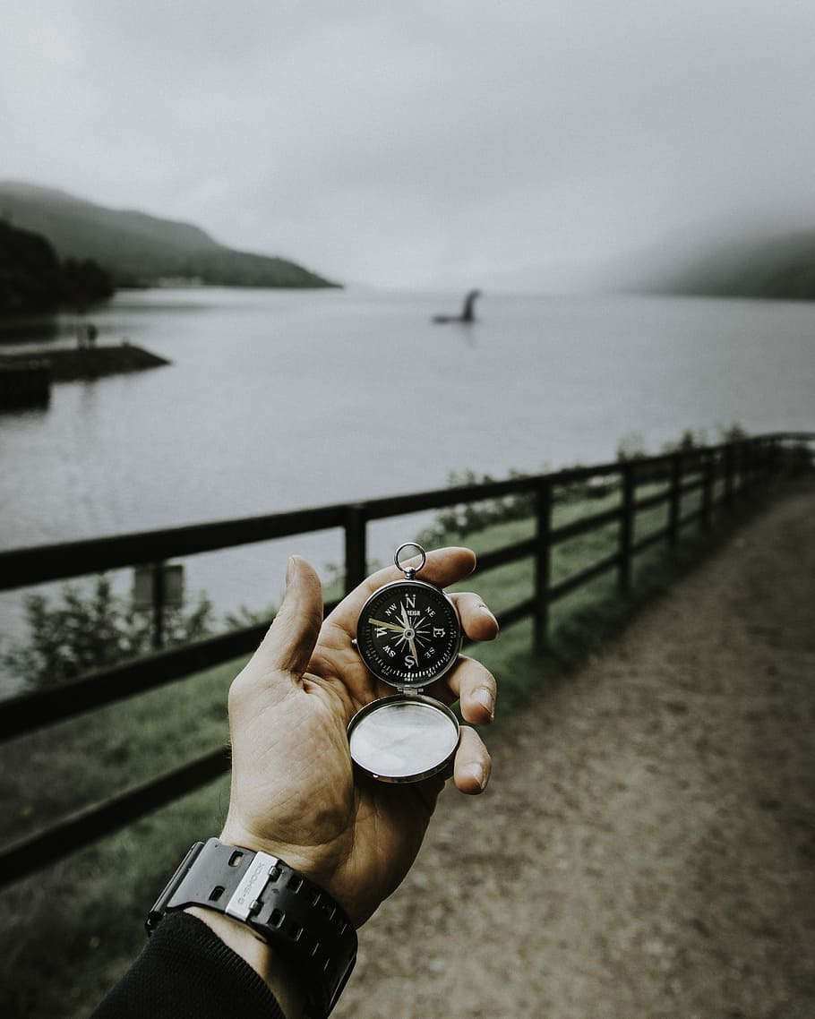person using compass that leads to Loch Ness place, person holding silver-colored pocket watch, HD wallpaper