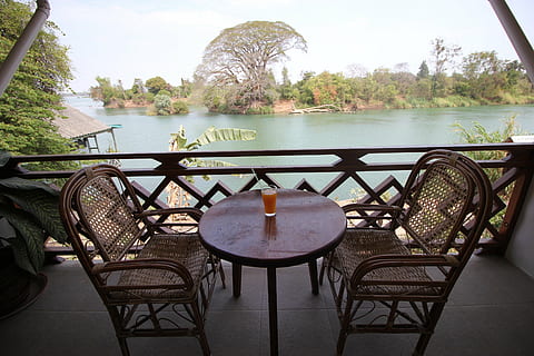 clear drinking glass on round brown wooden table, don det, laos HD wallpaper
