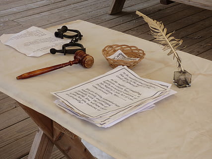 photography of white printed paper near brown wooden mallet and feather pencil on table HD wallpaper
