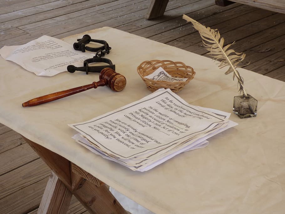 photography of white printed paper near brown wooden mallet and feather pencil on table HD wallpaper