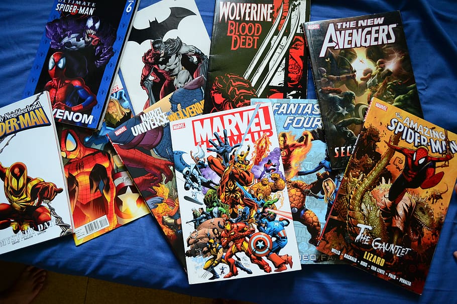 assorted comic book lot on blue textile, comics, novels, superhero