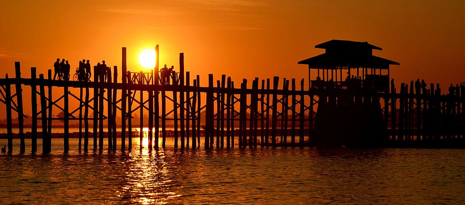 silhouette photo of wooden dock with hut at golden hour, U-Bein Bridge