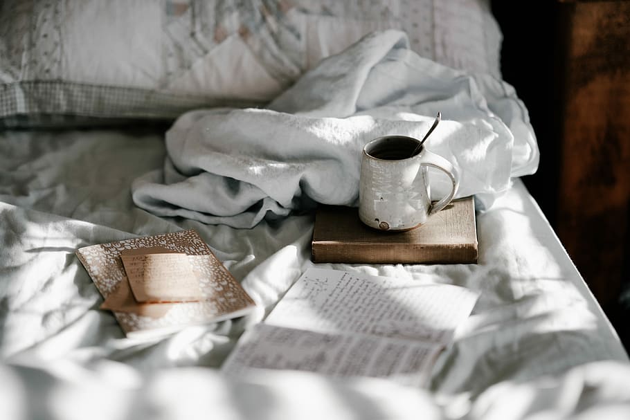 white and gray bed sheet, white mug on brown board beside white textile HD wallpaper