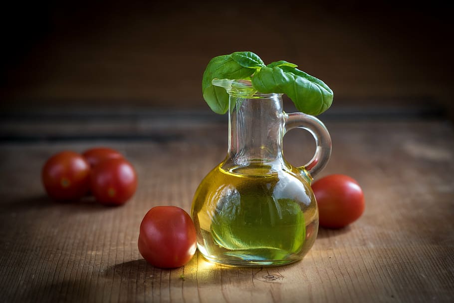 glass jug filled with oil with tomatoes on the table, olive oil, HD wallpaper