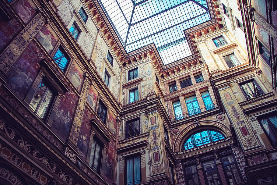 low angle photo of architectural structure, worms eye view of brown commercial building during daytime HD wallpaper