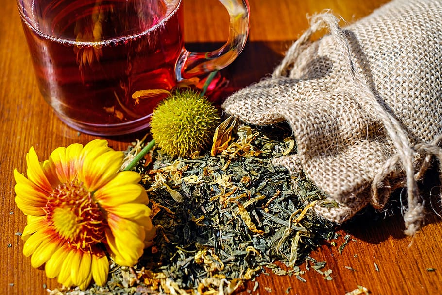 yellow flower between pouch and clear glass teacup, tee, herbs HD wallpaper