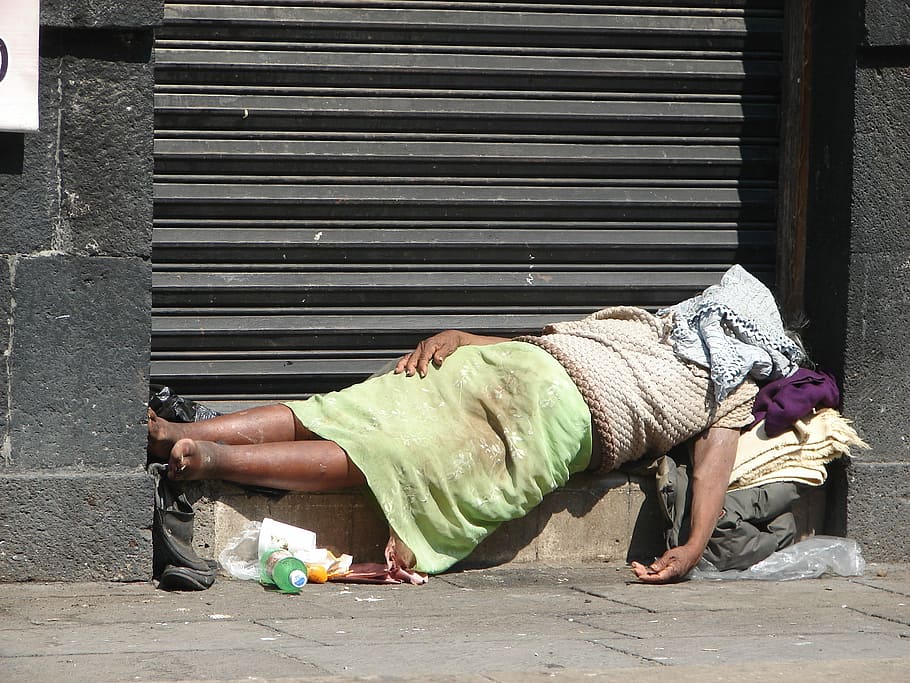 person sleeping beside rolling door, Homeless, Mexico City, Mexico