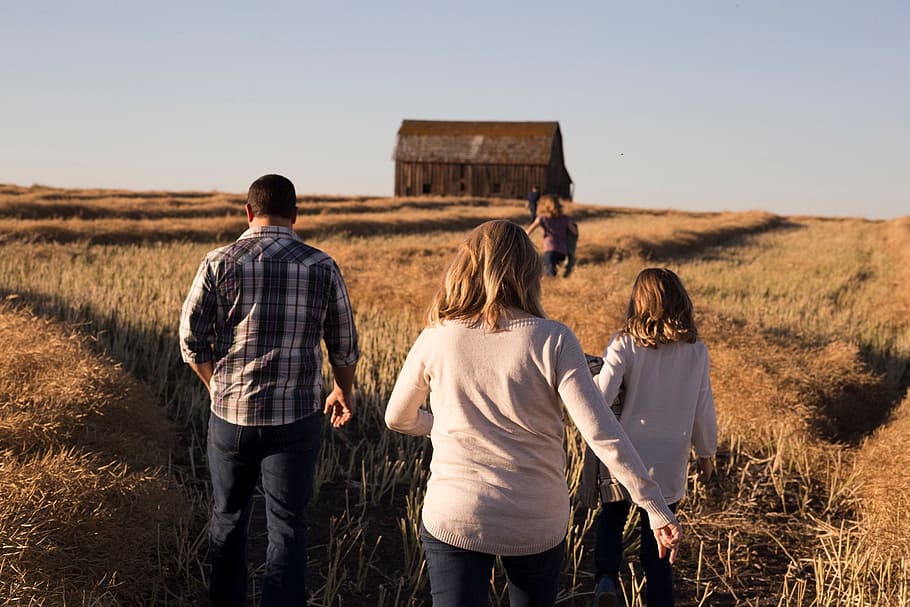 two women and one man on field during daytime, sky, house, hut HD wallpaper