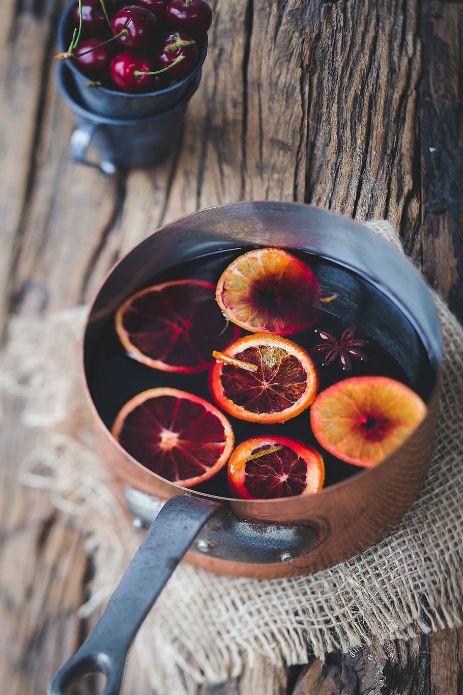 close-up photography of sliced orange fruit on brown cooking pot, sliced citrus on gray metal pan HD wallpaper