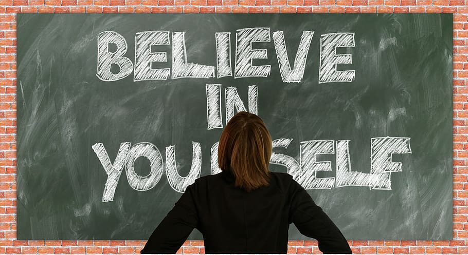 person in black long-sleeved top facing blackboard with believe in yourself text, HD wallpaper