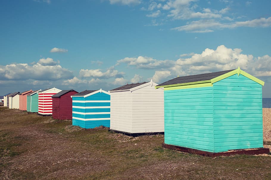 Coloured beach huts sit on the coast of Greatstone in Kent, Southern England. Image captured with a Canon DSLR HD wallpaper