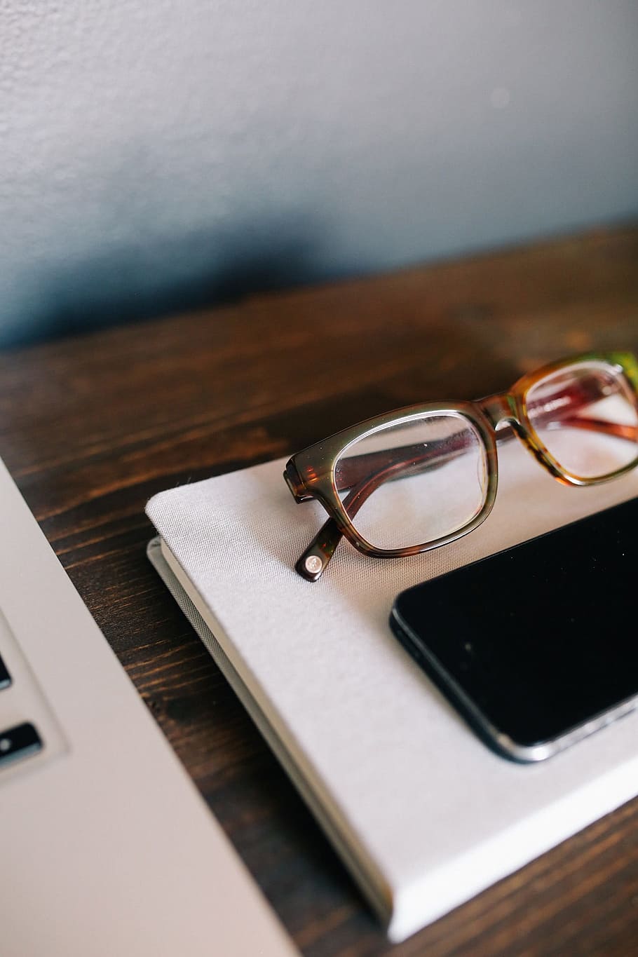 brown framed eyeglasses beside smartphone on table, mobile, cell phone, HD wallpaper