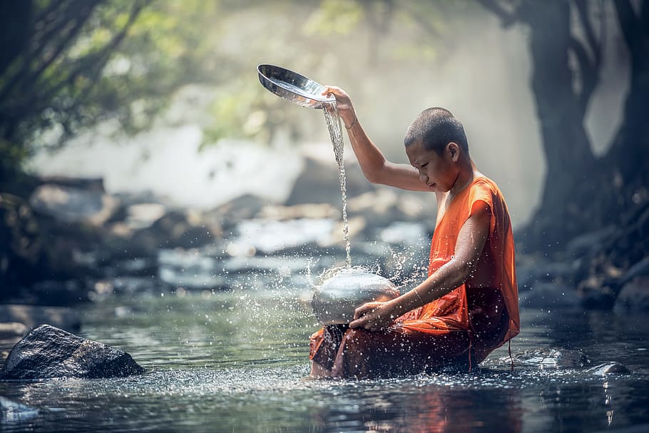 shallow focus photography of monk pouring water on silver pot at river, HD wallpaper