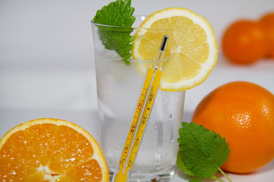 yellow thermometer beside glass of water with sliced lemon HD wallpaper