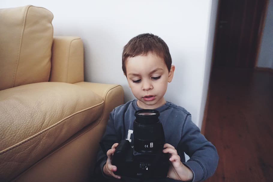 Boy Holding Black Dslr Camera, child, curious, cute, kid, room HD wallpaper