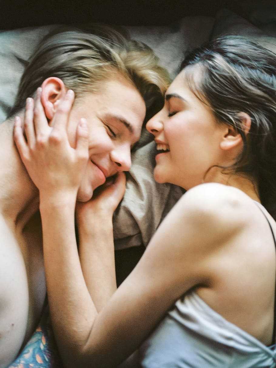 man and woman in white top laying on bed, couple, love, feelings
