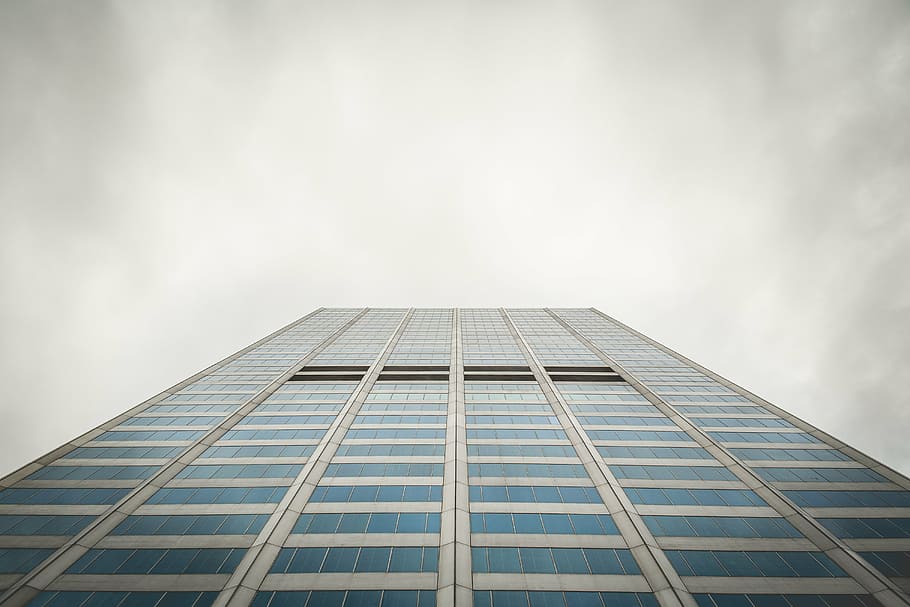 view of skyscraper from ground under cloudy sky during daytime HD wallpaper