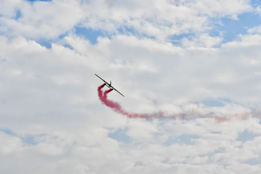 Model Plane in the Sky, black and red fly past plane at day time HD wallpaper