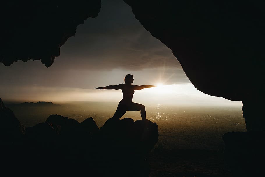 silhouette of woman doing yoga on rock during golden hour, people HD wallpaper