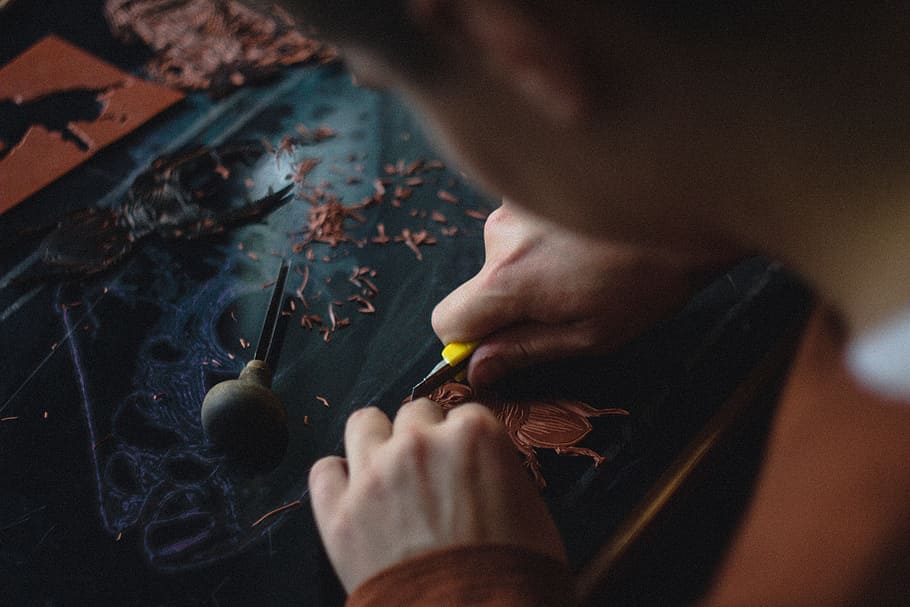 person carving on black wood plank, person using utility knife doing artwork, HD wallpaper