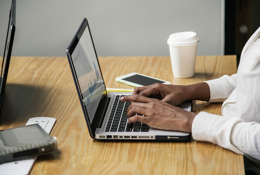 man working in front of silver laptop computer on table, desk, HD wallpaper