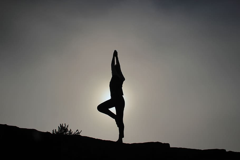 Yoga in nature. Silhouette of woman practice yoga meditation exercise  outdoor. Young female sitting on mountains for relaxed yoga posture in the  morning, mental health care, relaxation, meditation. Stock Photo | Adobe