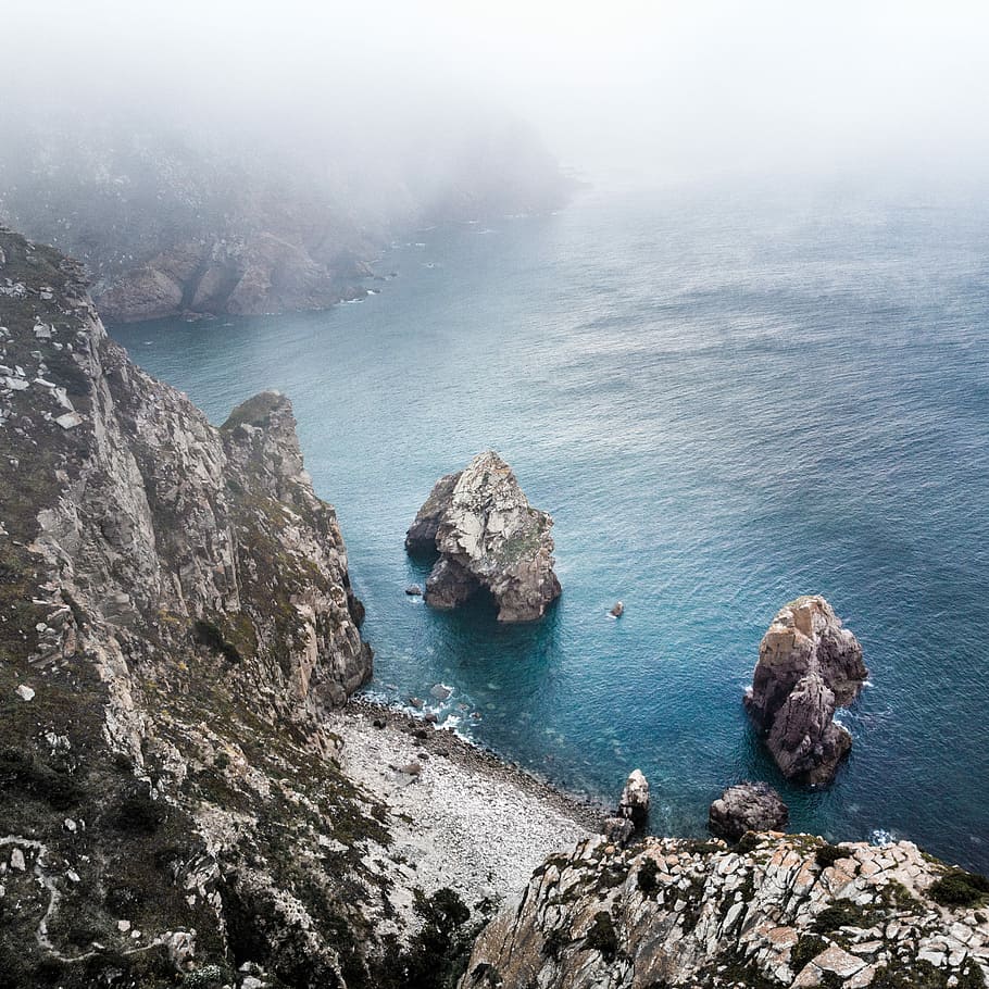 boulders on body of water, gray rock formation near ocean, cloudy HD wallpaper