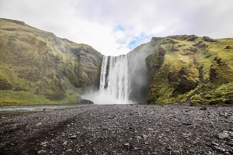 photo of waterfall near mountain under blue sky at daytime, skogafoss in Iceland at daytime HD wallpaper