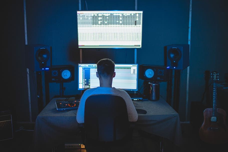 man sitting in front of computer, man using computer, male, speakers HD wallpaper