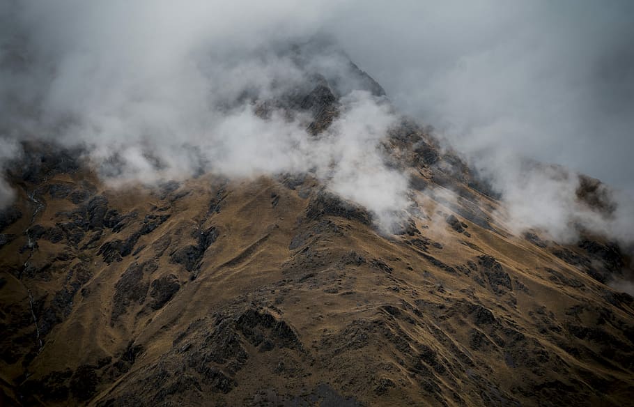 bird's-eye view photography of brown mountain, mountain covered with fog during daytime HD wallpaper
