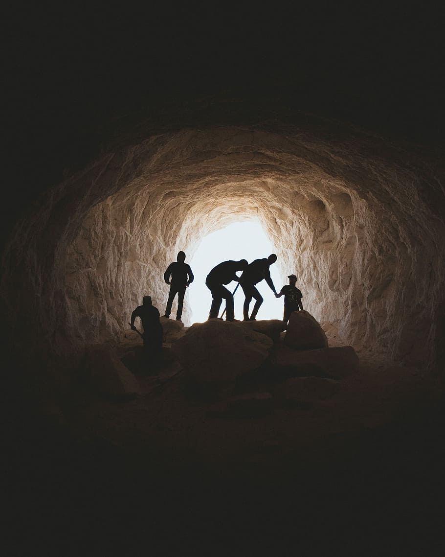 photo of people in cave, silhouette of people inside cave near open area at daytime HD wallpaper