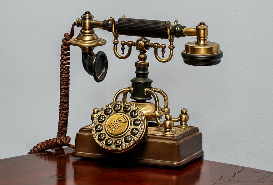 closeup photo of vintage brown rotary dial phoine, telephone