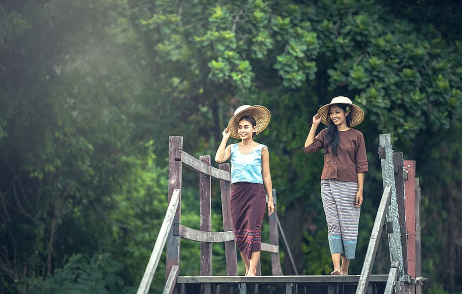 two women with hat walking on gray wooden bridge during daytime, HD wallpaper